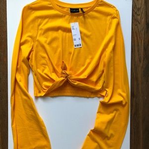 Out from under knotted long flare sleeves crop top